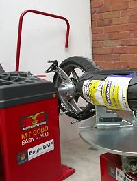Motor cycle wheel balancing machine